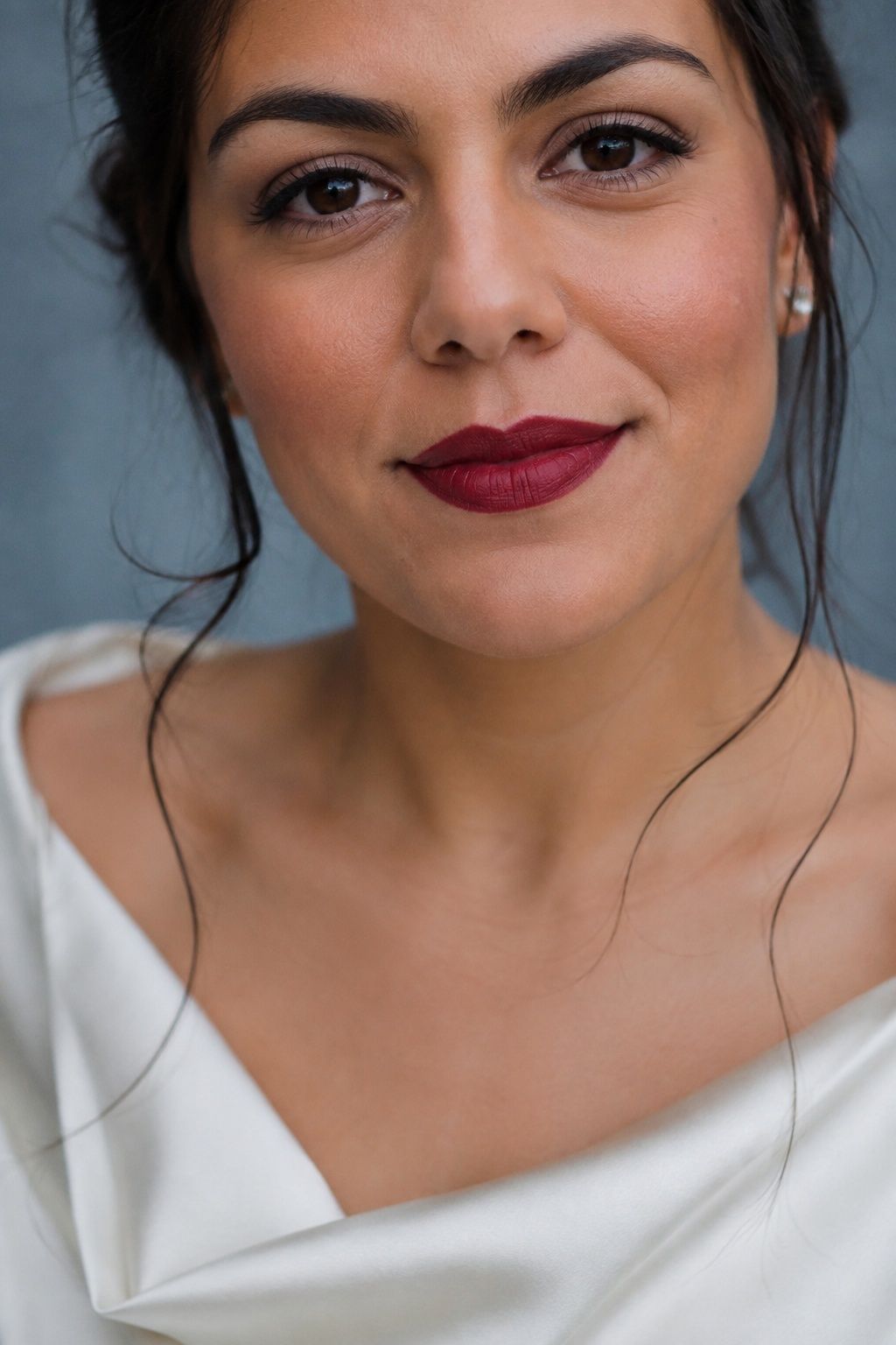 Precisely lined garnet berry lipstick with a soft bridal finish.