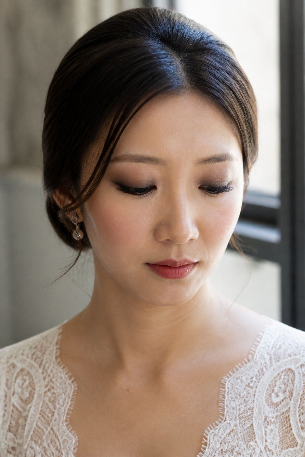 Diffused charcoal and taupe smoky eyes with soft bridal makeup.