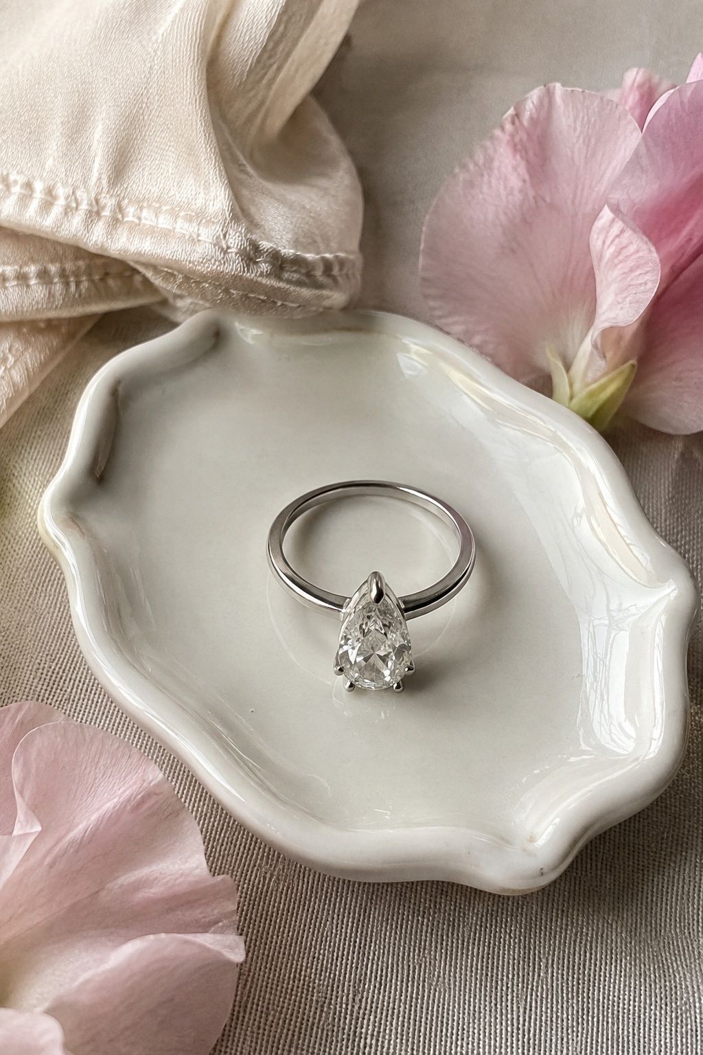 Pear shaped diamond ring with a delicate point