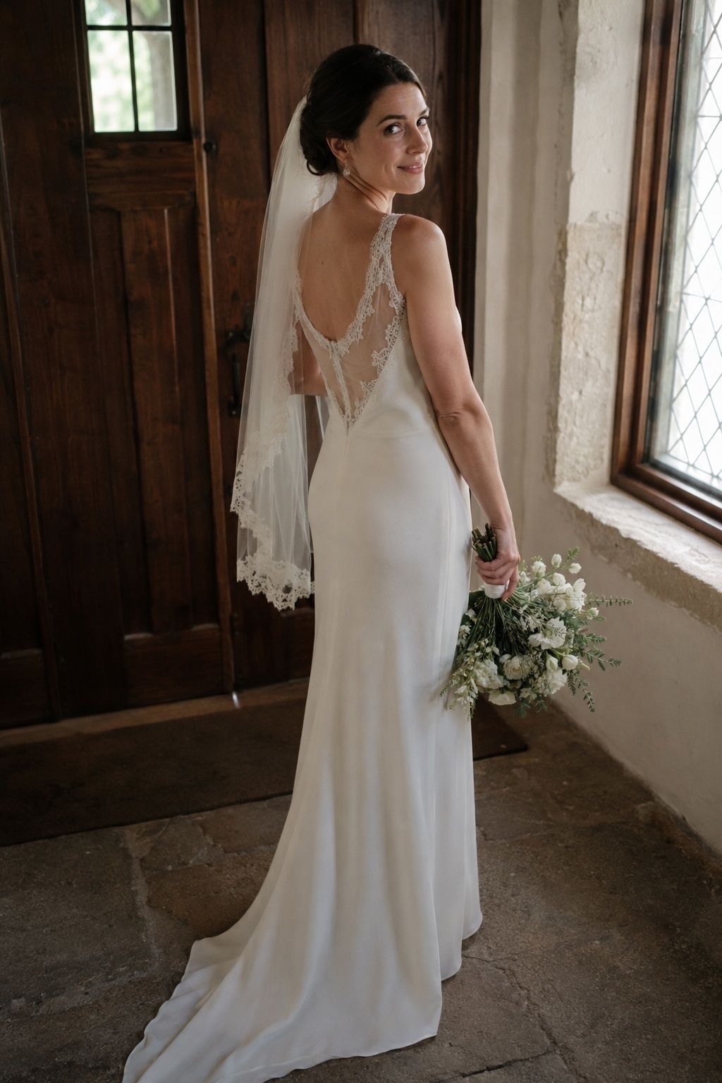 Bride in a minimal wedding dress with subtle matte lace accents