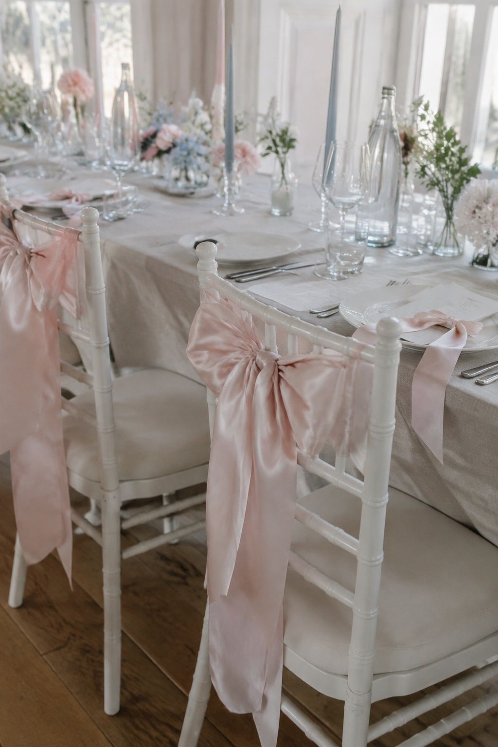 Satin bows tied on reception chairs and menus