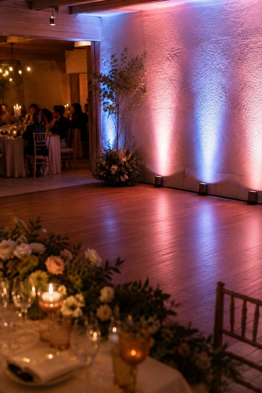 Soft pink and blue uplighting over the dance floor