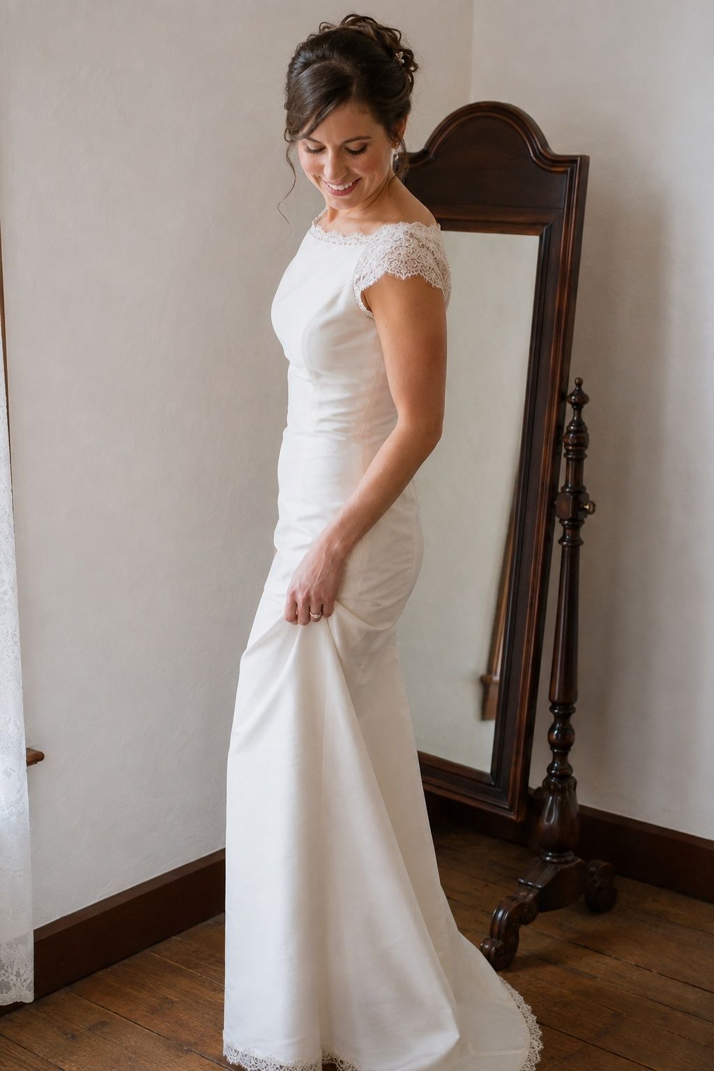 Bride in a mostly plain 1990s wedding sheath with lace neckline sleeves and hem accents