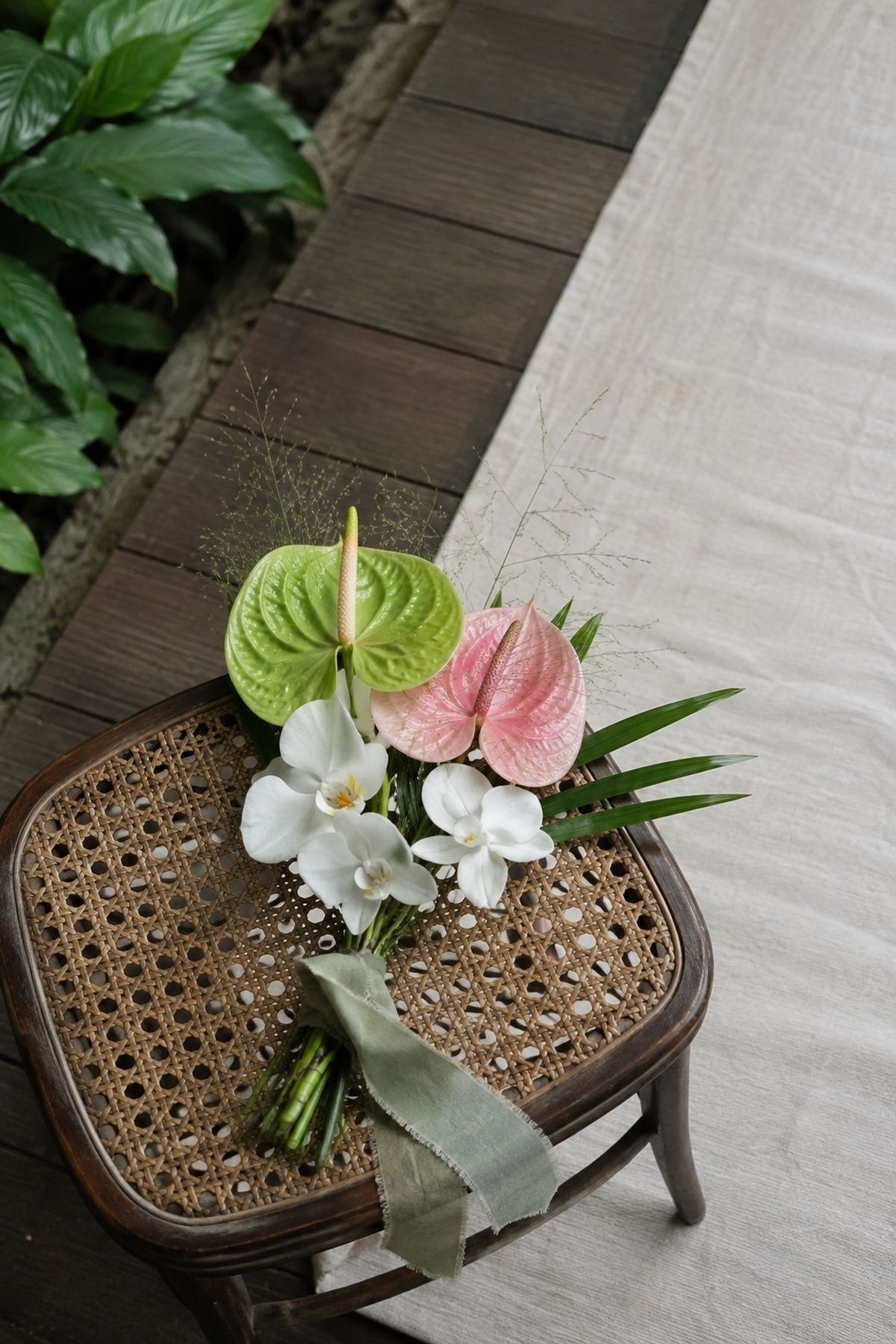 Tropical anthurium bouquet with palm leaves