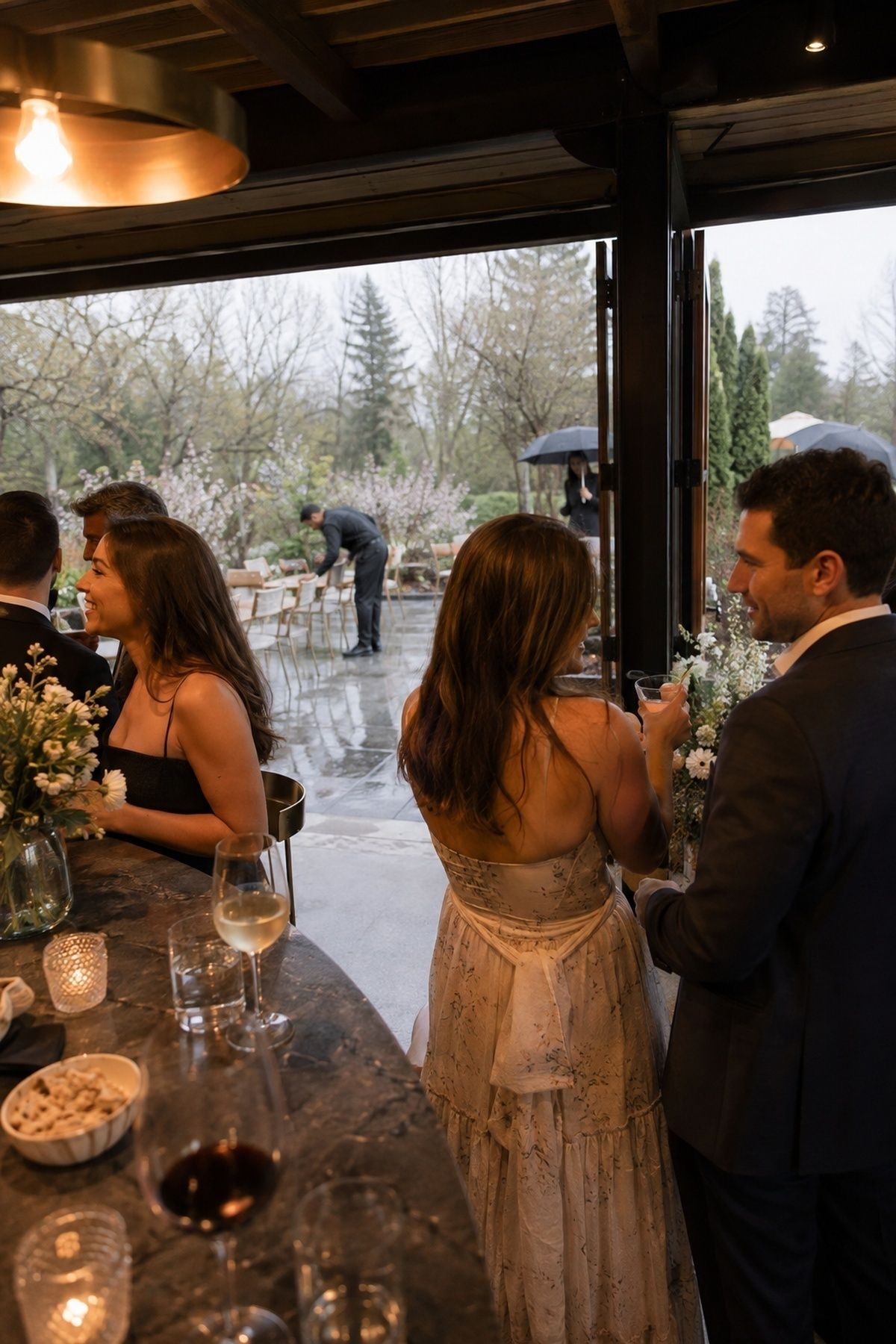 Flexible cocktail hour moving between covered and open space during spring showers