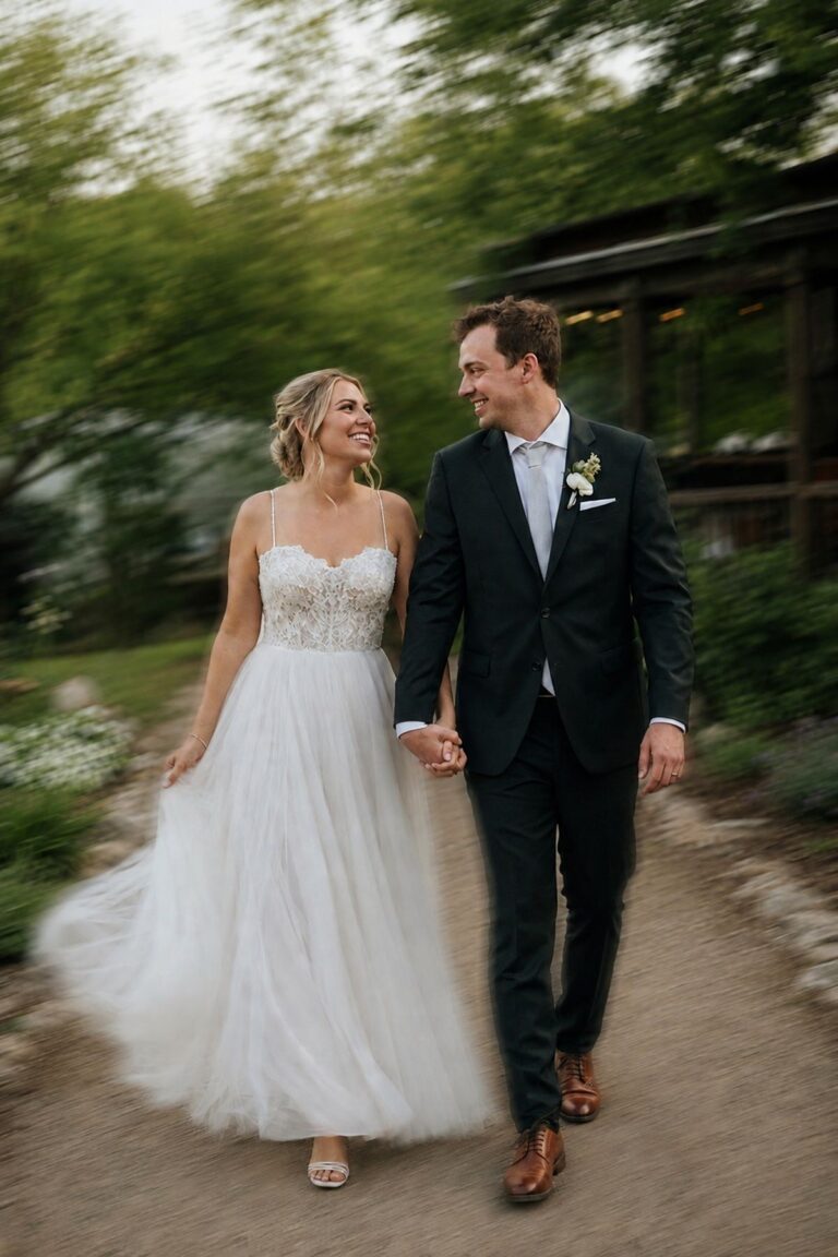 Newlyweds walking hand in hand with intentional motion blur on a garden path
