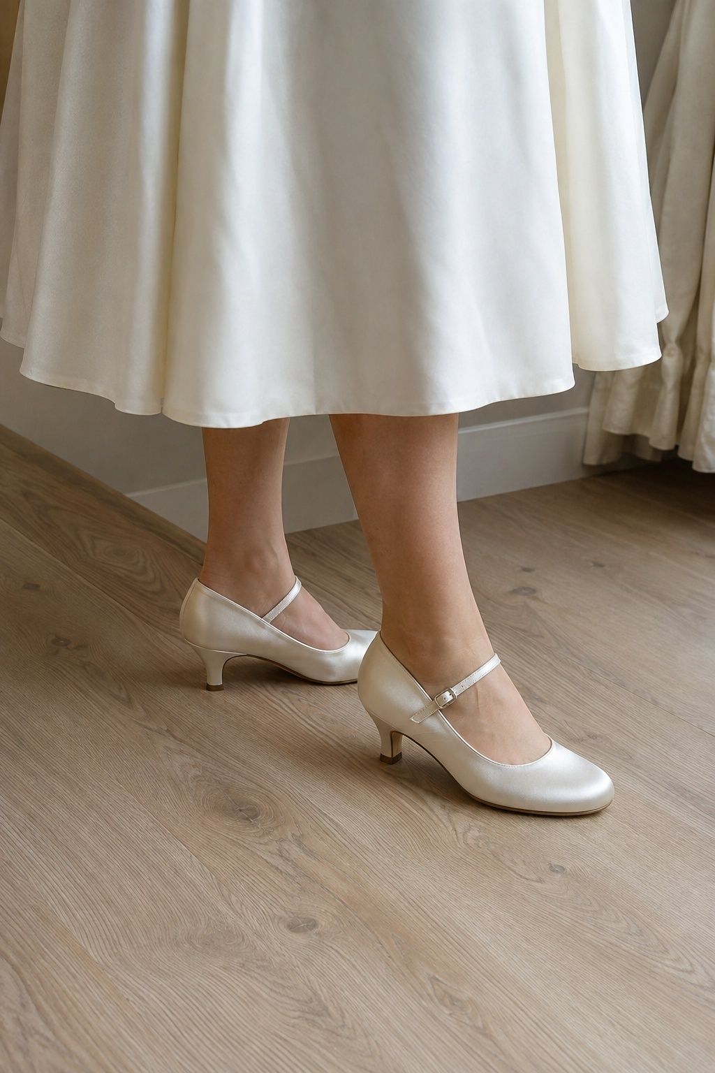 Ivory Mary Jane heels visible below a tea-length bridal dress