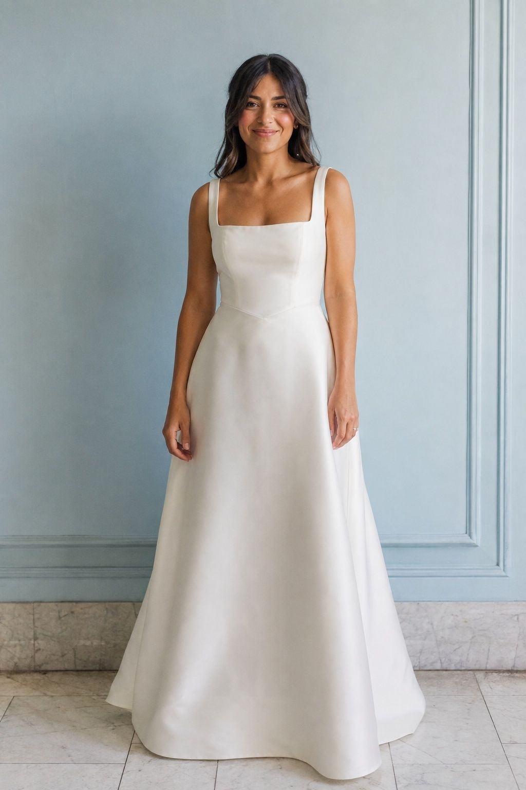 Square neckline and softly dipped waist on an ivory mikado gown