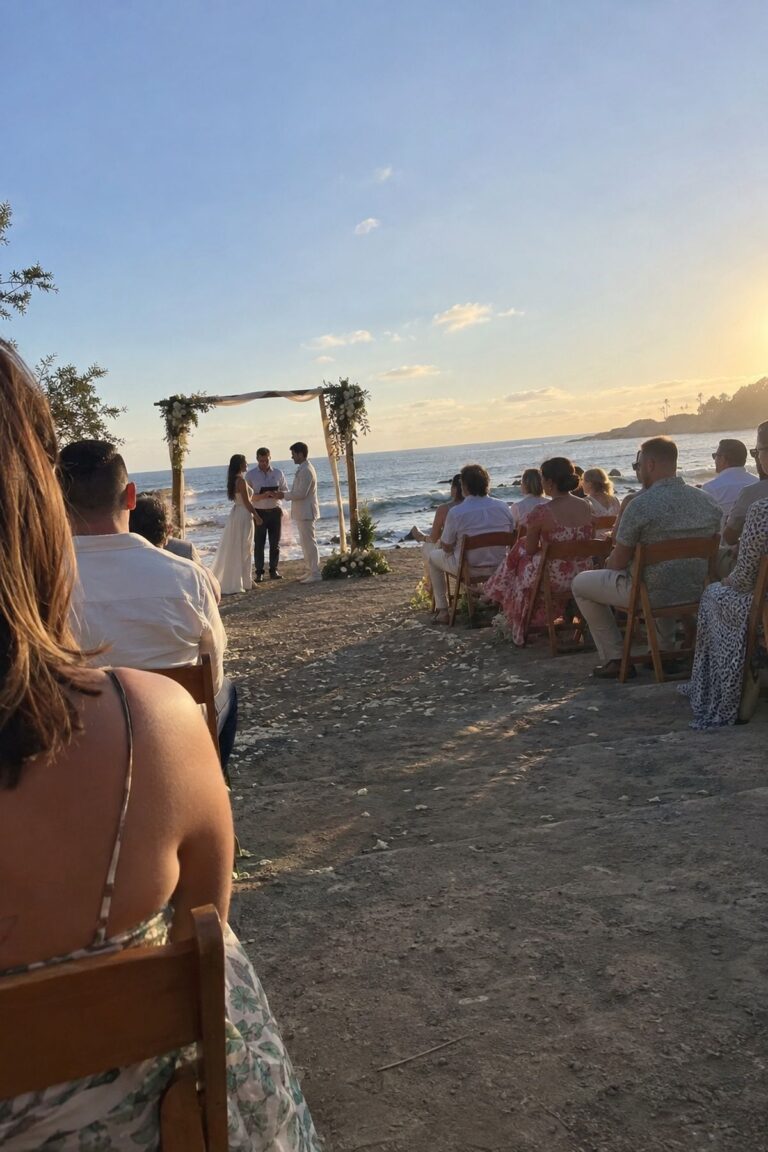 Guests sit comfortably during a late-afternoon beach wedding ceremony away from harsh midday sun.