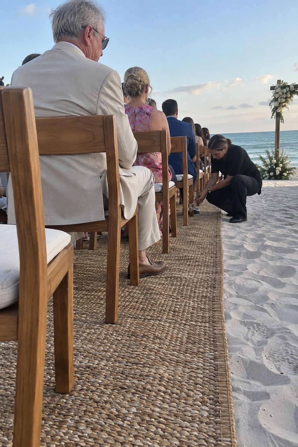 Stable broad-footed chairs sit level on a low platform over beach sand.