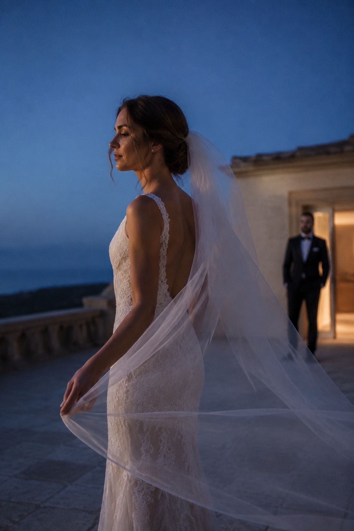 Bride's sheer veil catching a gentle evening breeze during blue hour