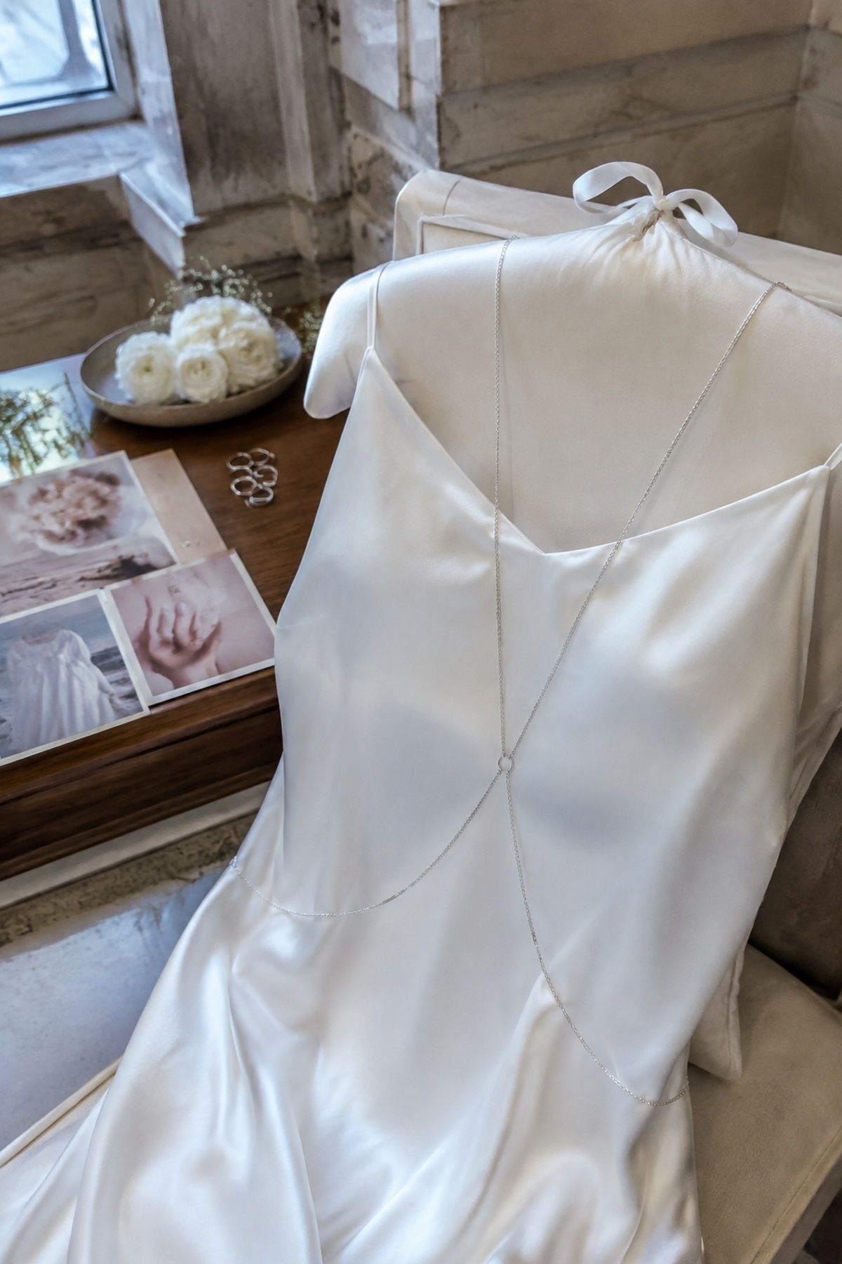 Fine silver body chain layered over a bridal slip dress
