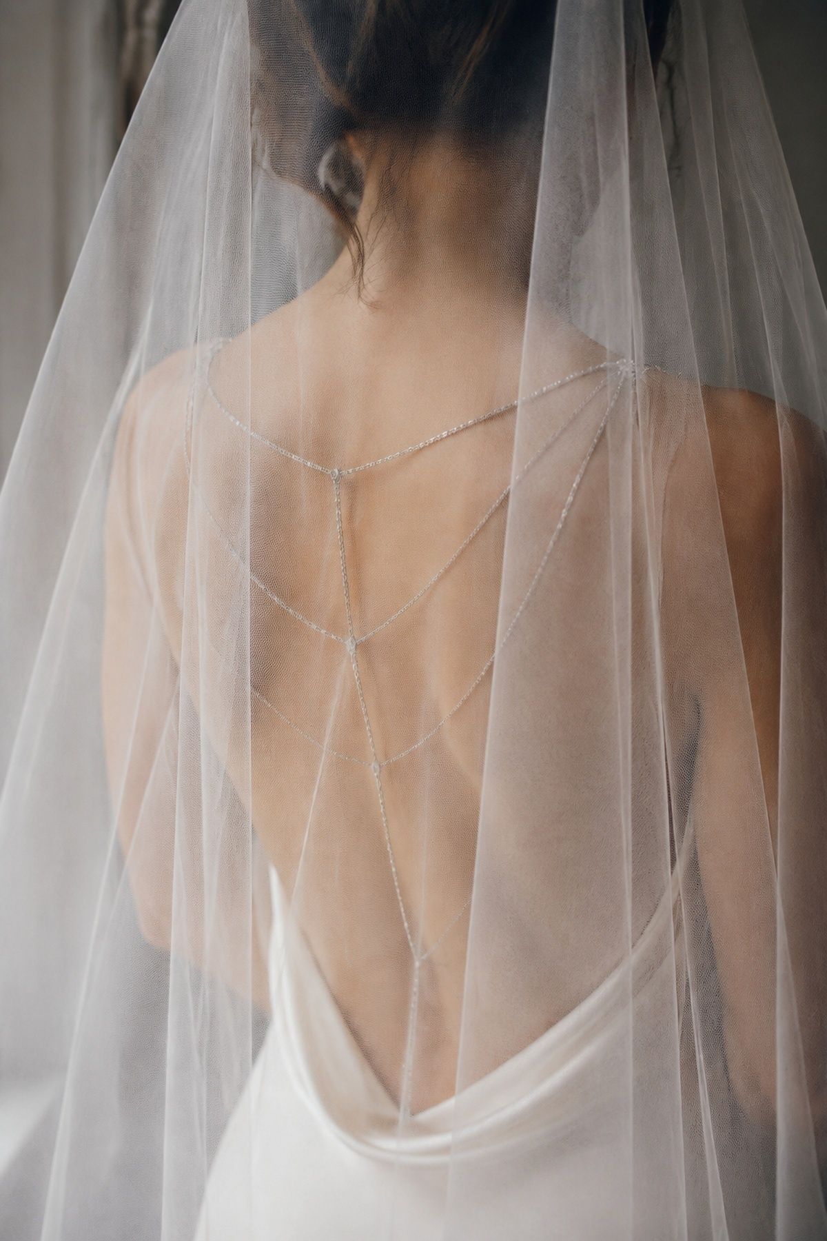 Bridal body chain worn under a plain veil