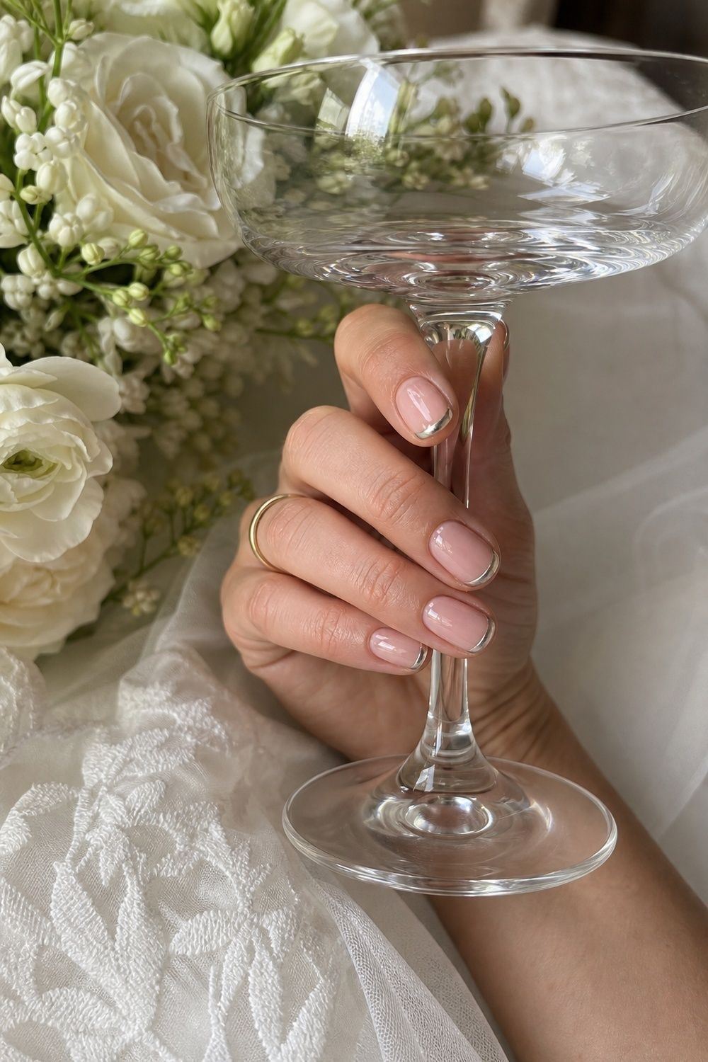 Chrome French tips on short oval nails