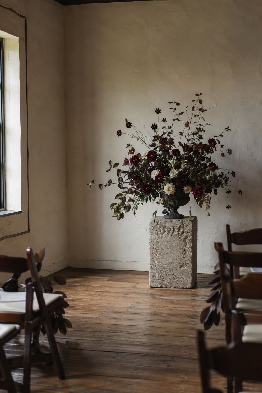 Espresso and burgundy flowers in a ceremony corner