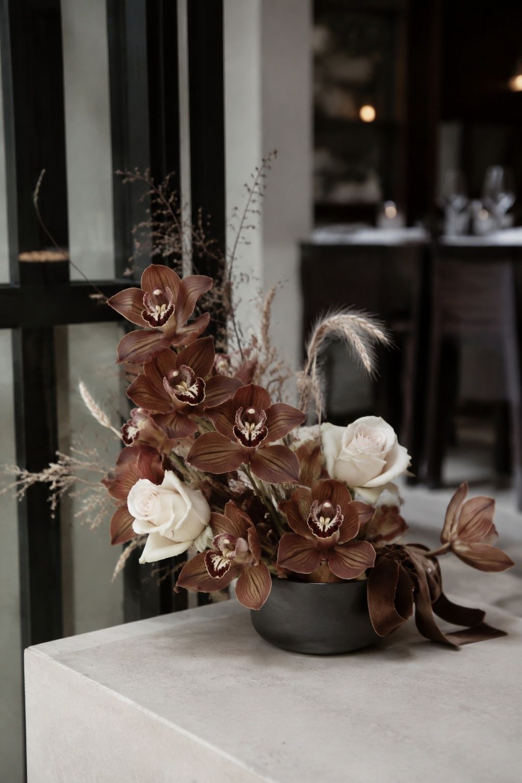 Brown orchids in a modern floral arrangement