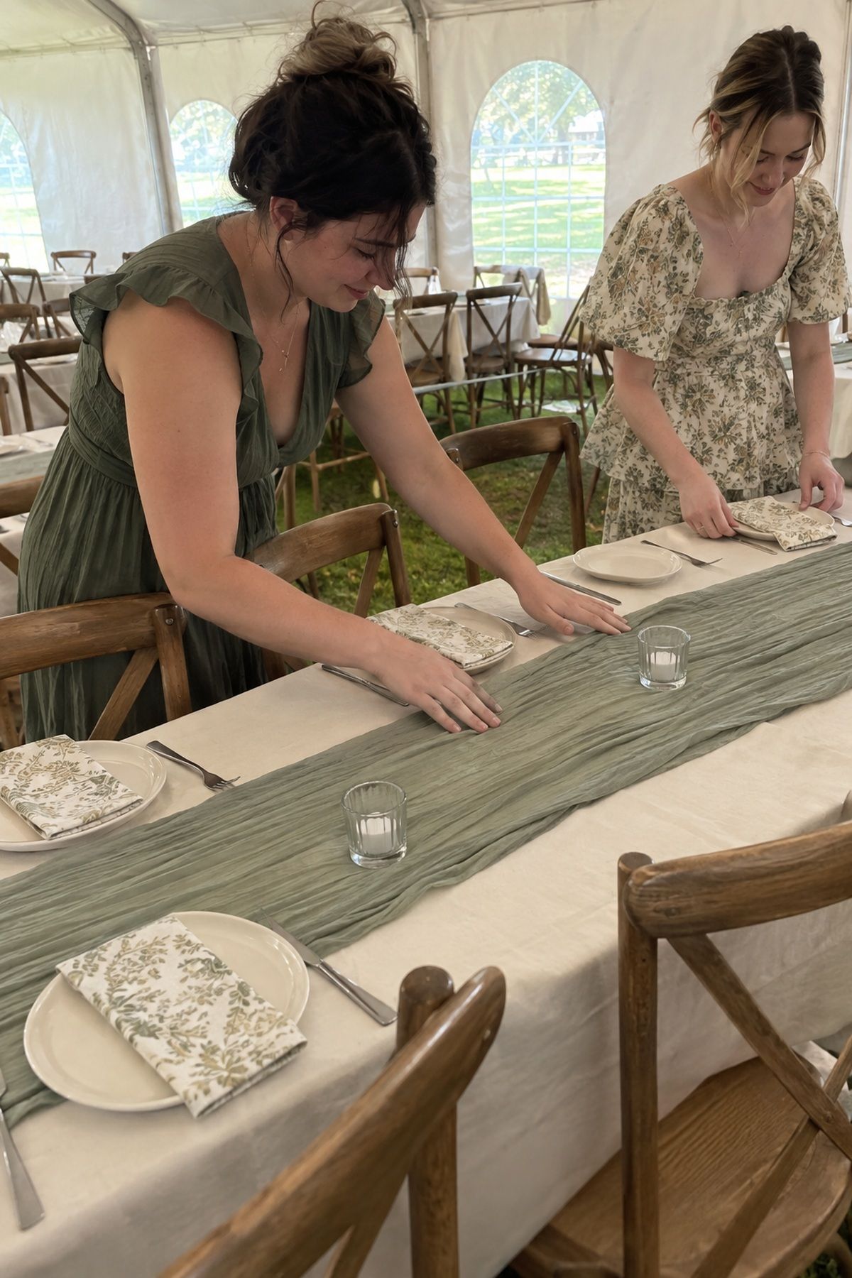Two friends use a sage runner and patterned napkins to style a simple spring reception table.