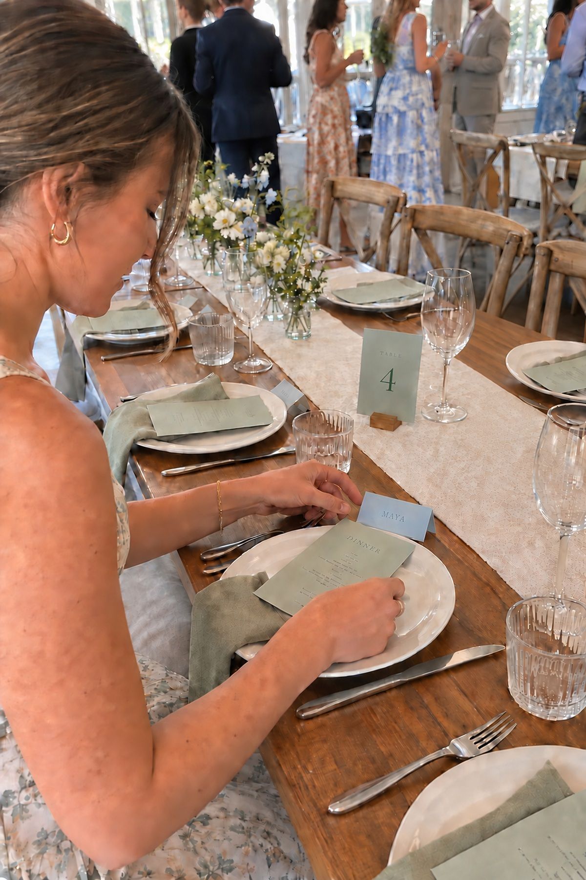 Sage menus, blue place cards, and a matching table number carry the spring color story.