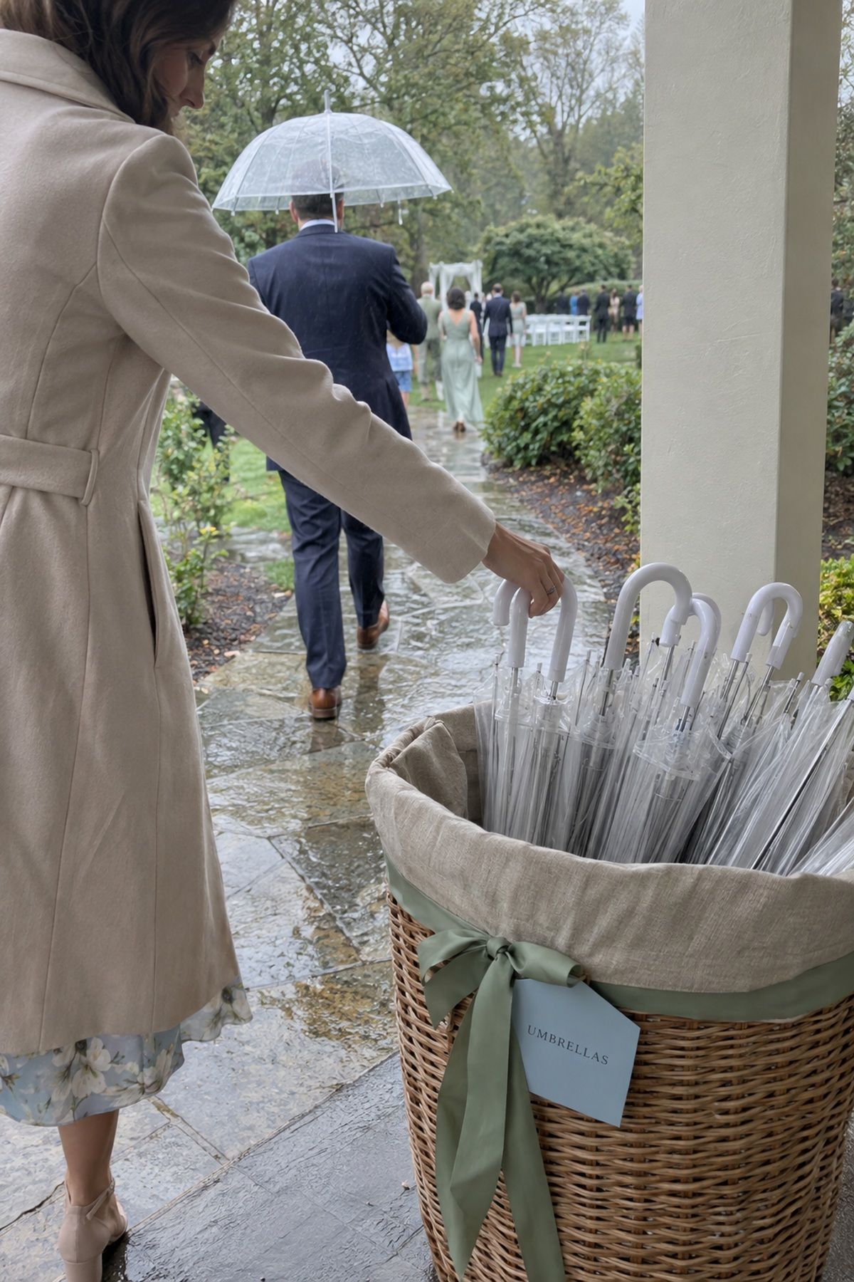 A guest takes a clear umbrella from a pretty linen-lined basket during a spring shower.