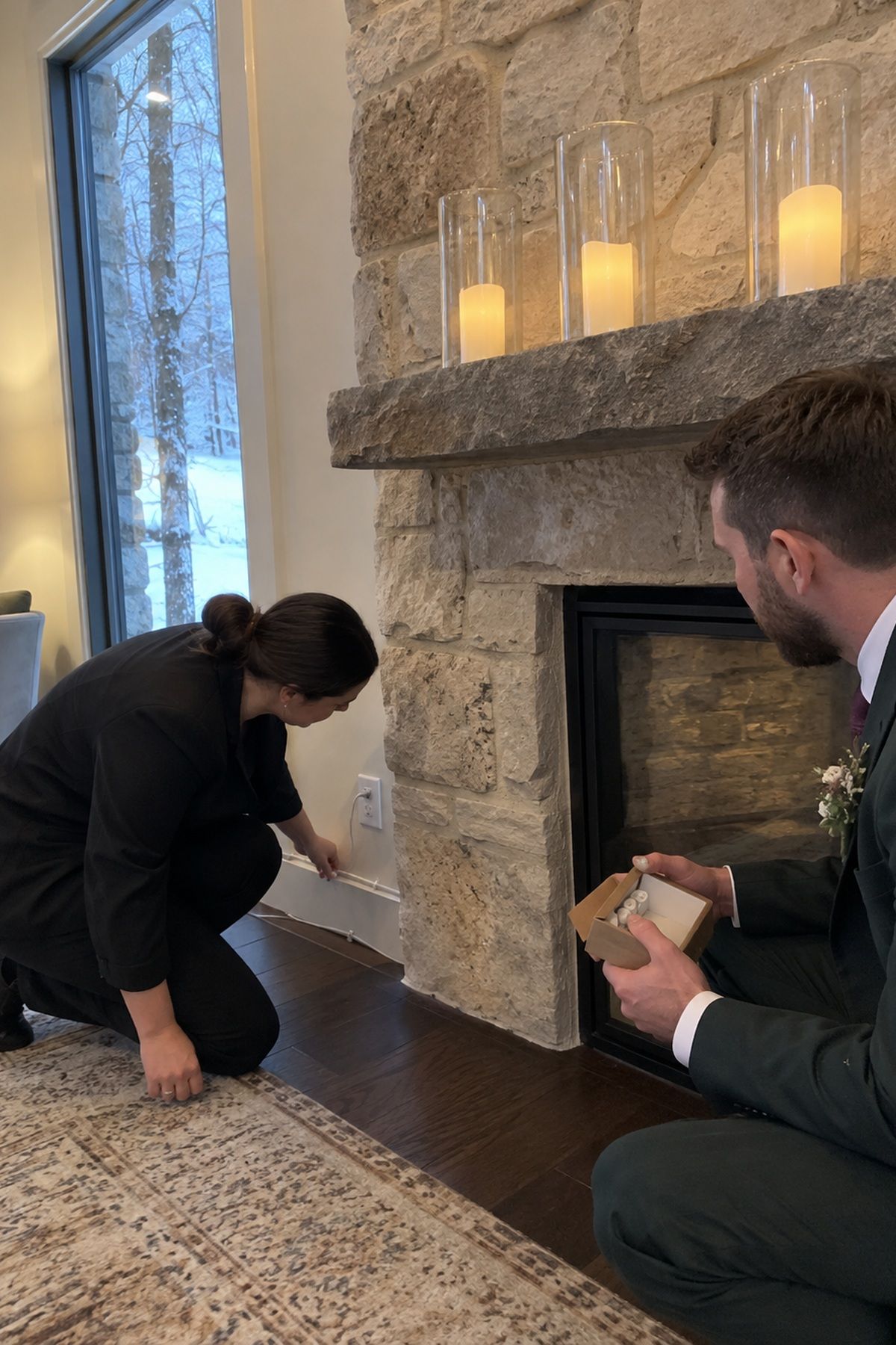 A coordinator and groom check protected LED candles, batteries, and a safely secured cable before the winter wedding.