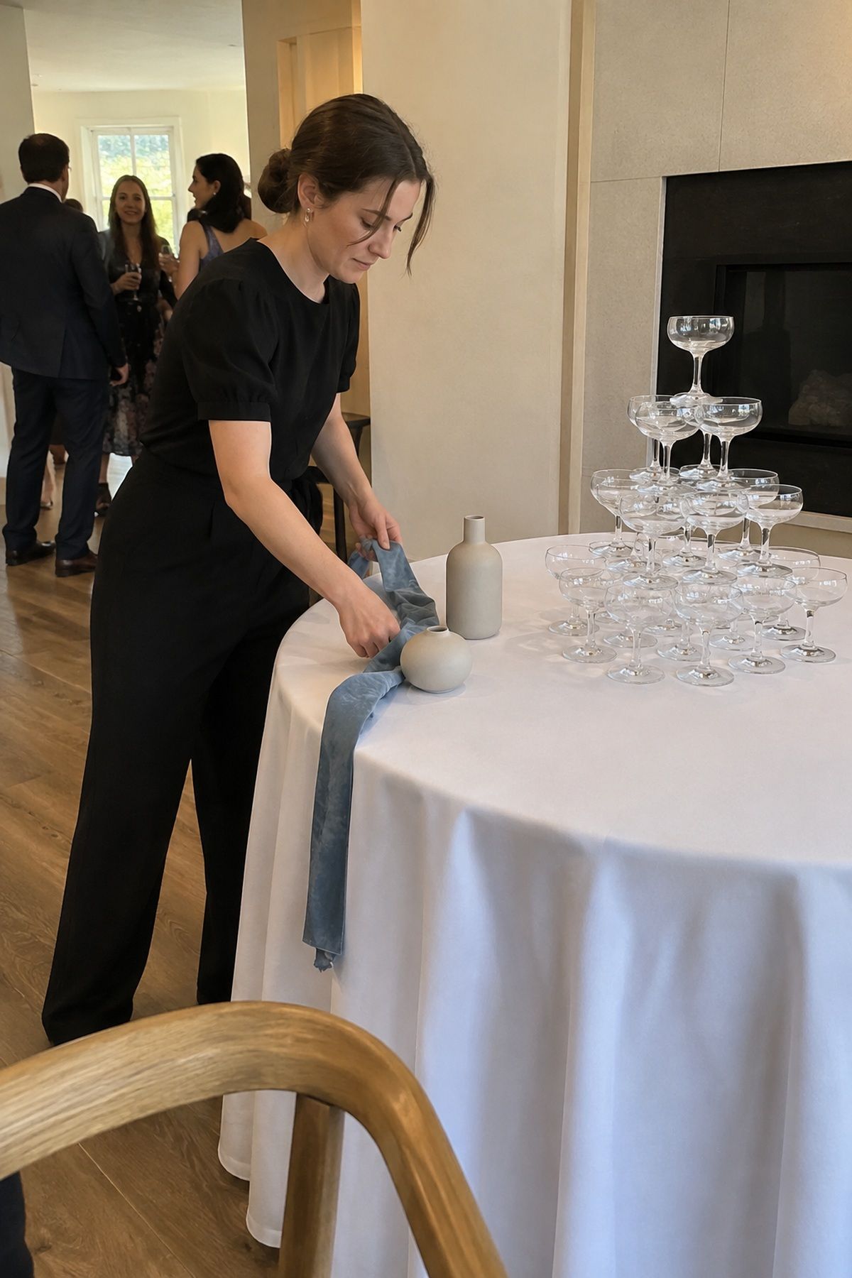 Restrained ribbon and ceramic details leave open service space around a champagne tower.