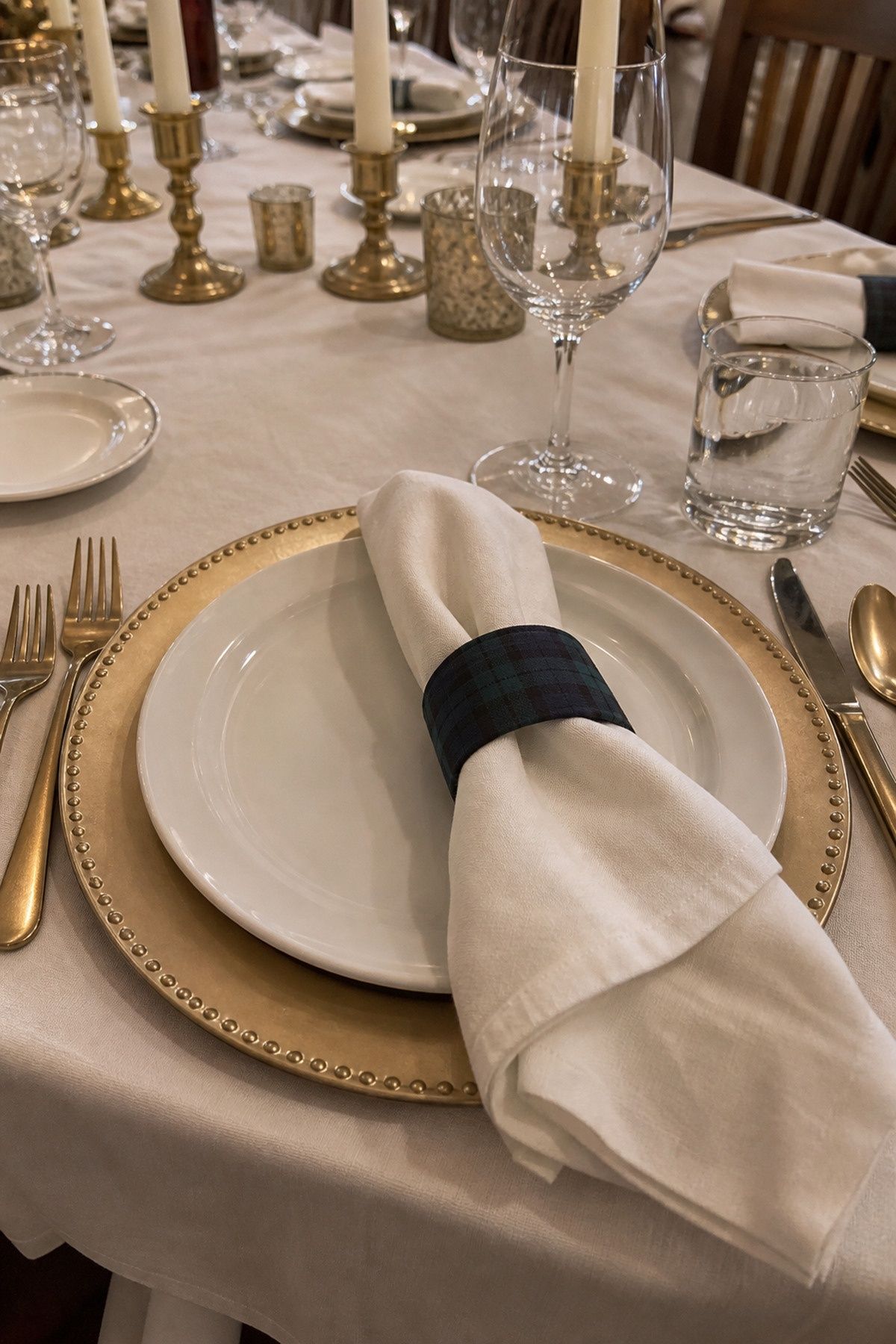 Single muted tartan napkin band at a mostly solid-color setting at an intimate Christmas wedding reception