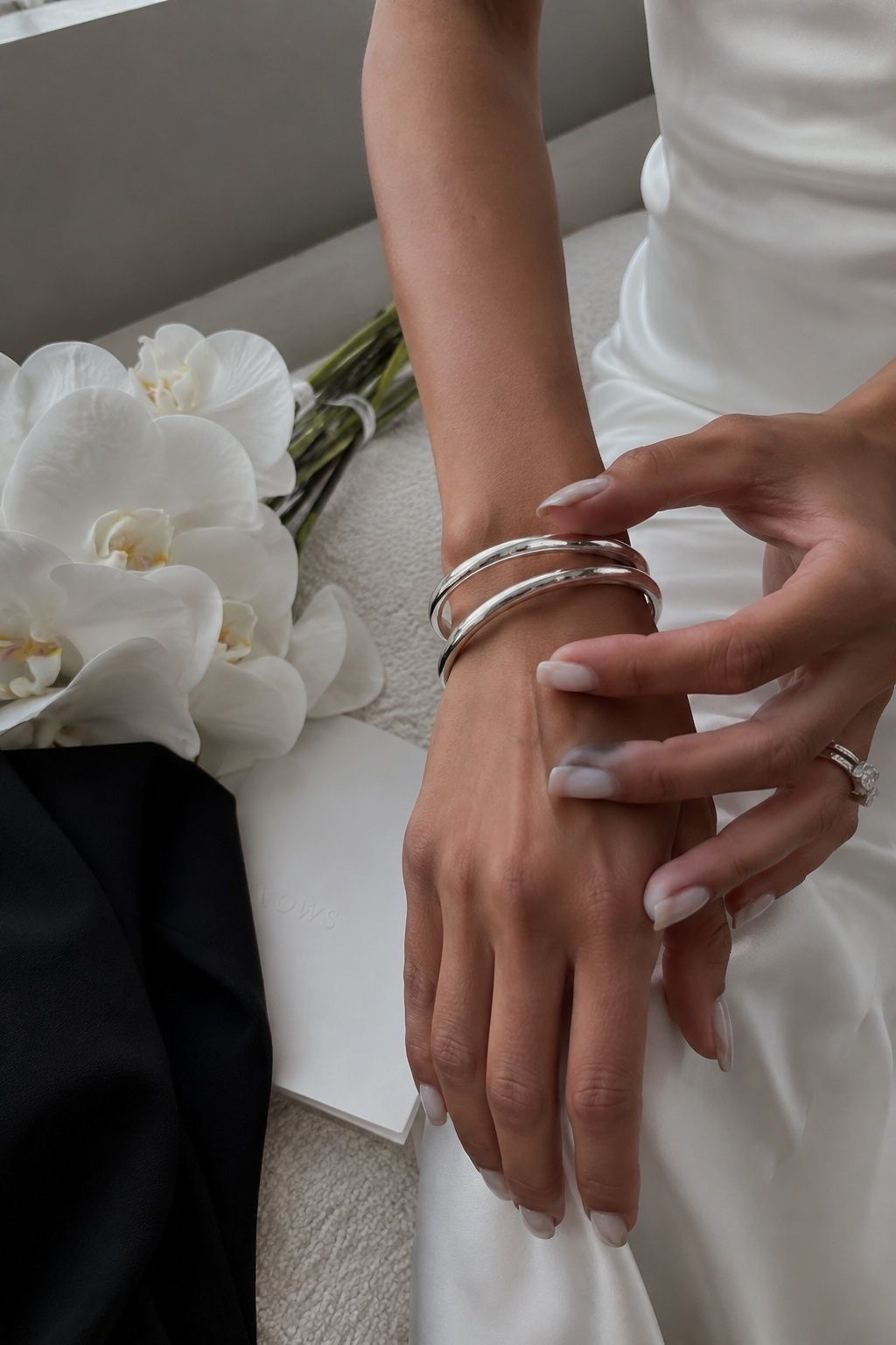Silver bangle stack for a cool-toned bridal look