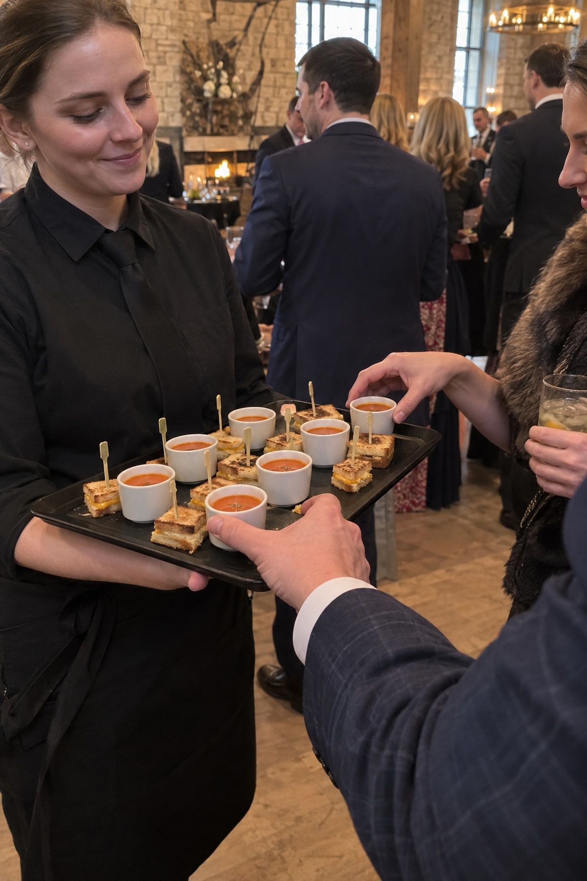 Guests take warm soup shooters and grilled cheese bites during cocktail hour.