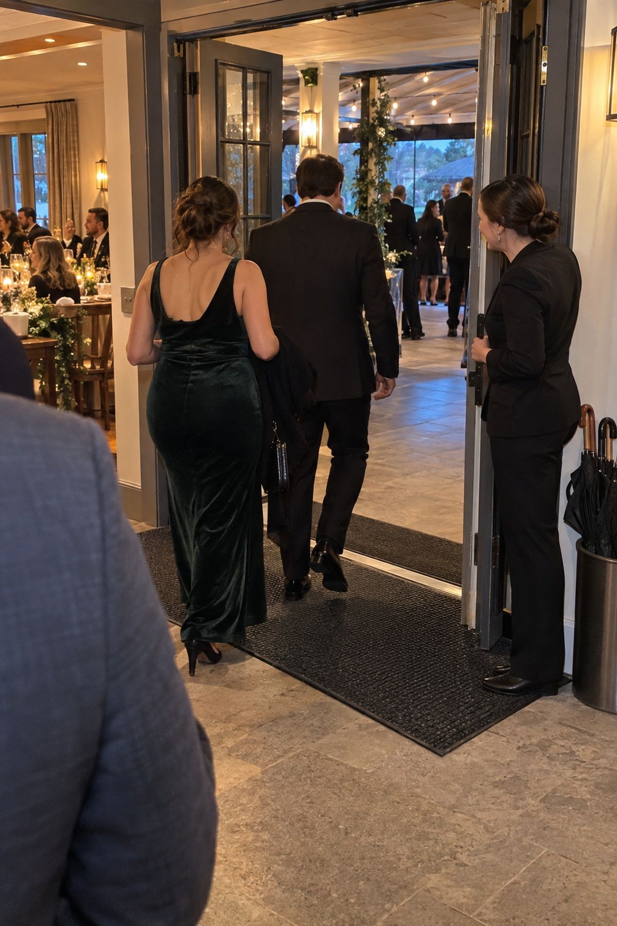 A coordinator guides guests across a clear warm transition between reception spaces.