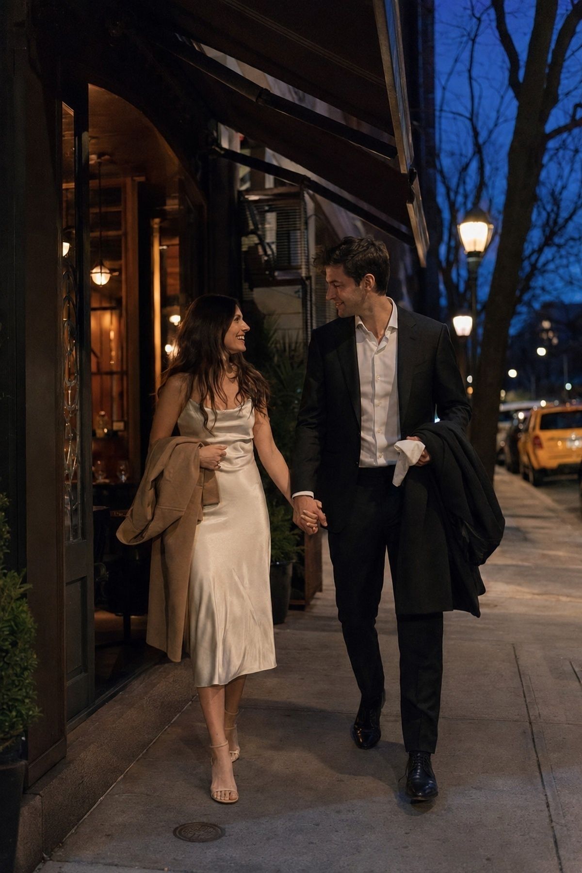 Dinner date engagement couple stepping outside between courses under an awning