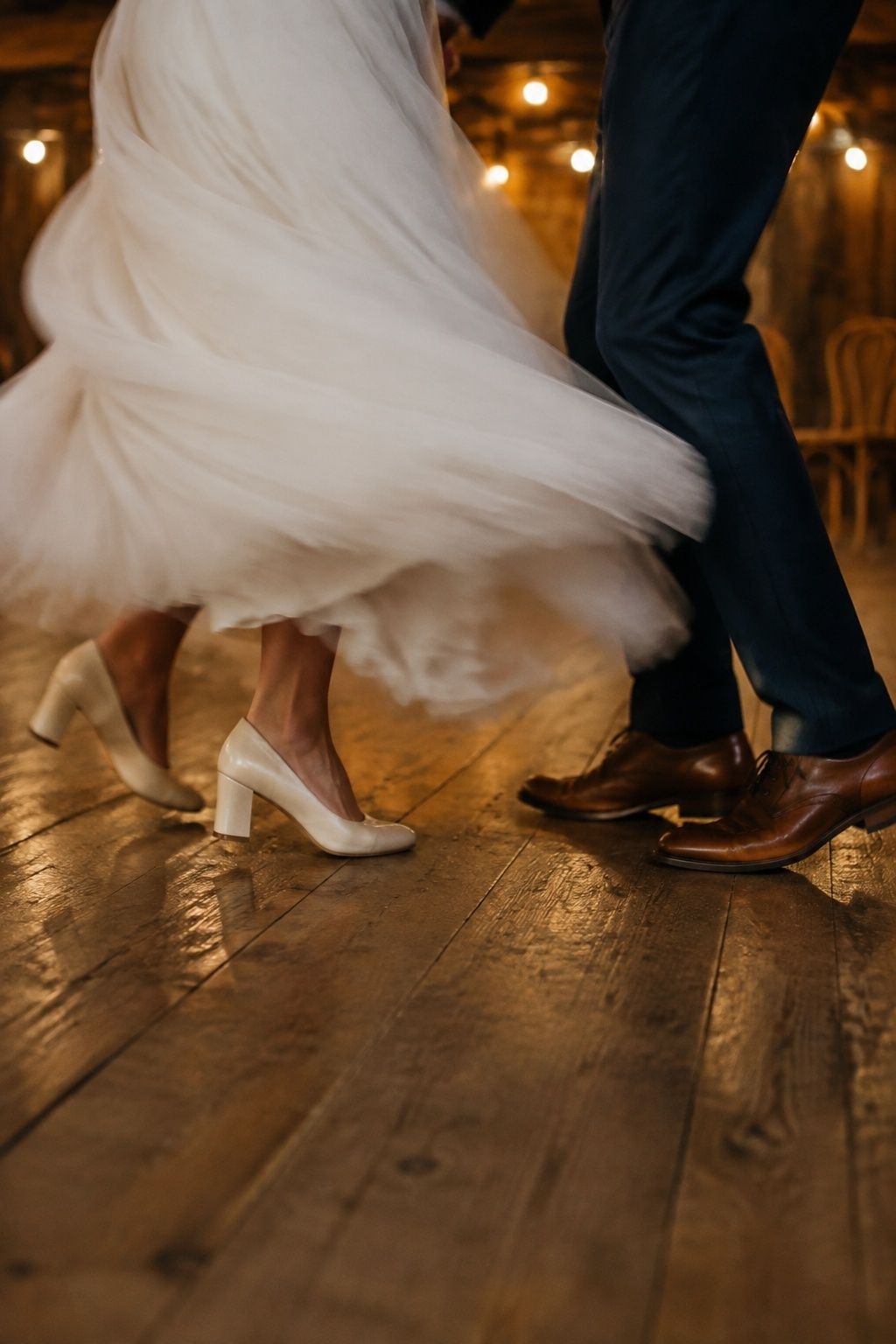 Low-angle wedding dance photo with intentional motion blur in the bride's spinning skirt