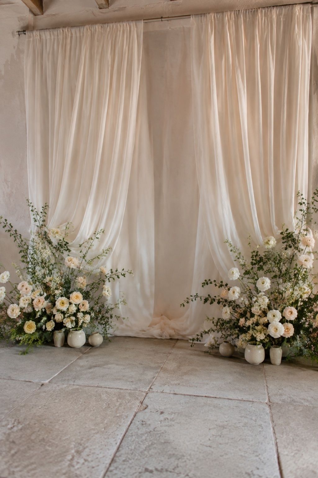 Fabric backdrop with low flowers at its base