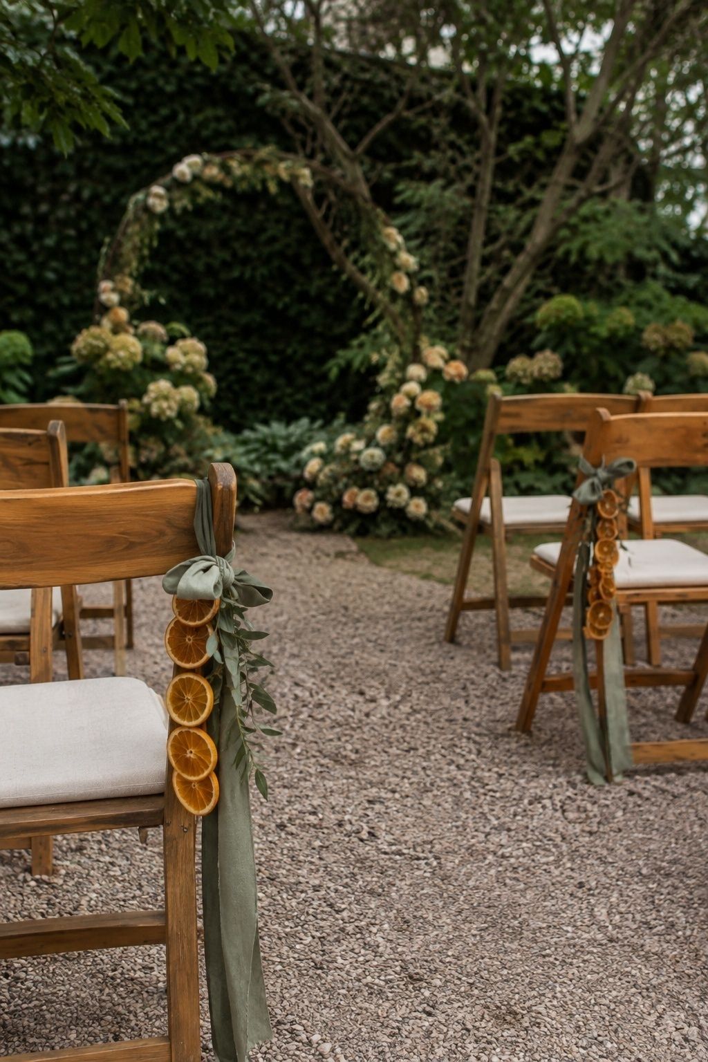 Add A Ceremony Chair Accent Instead Of A Full Aisle Installation with dried orange wedding garland