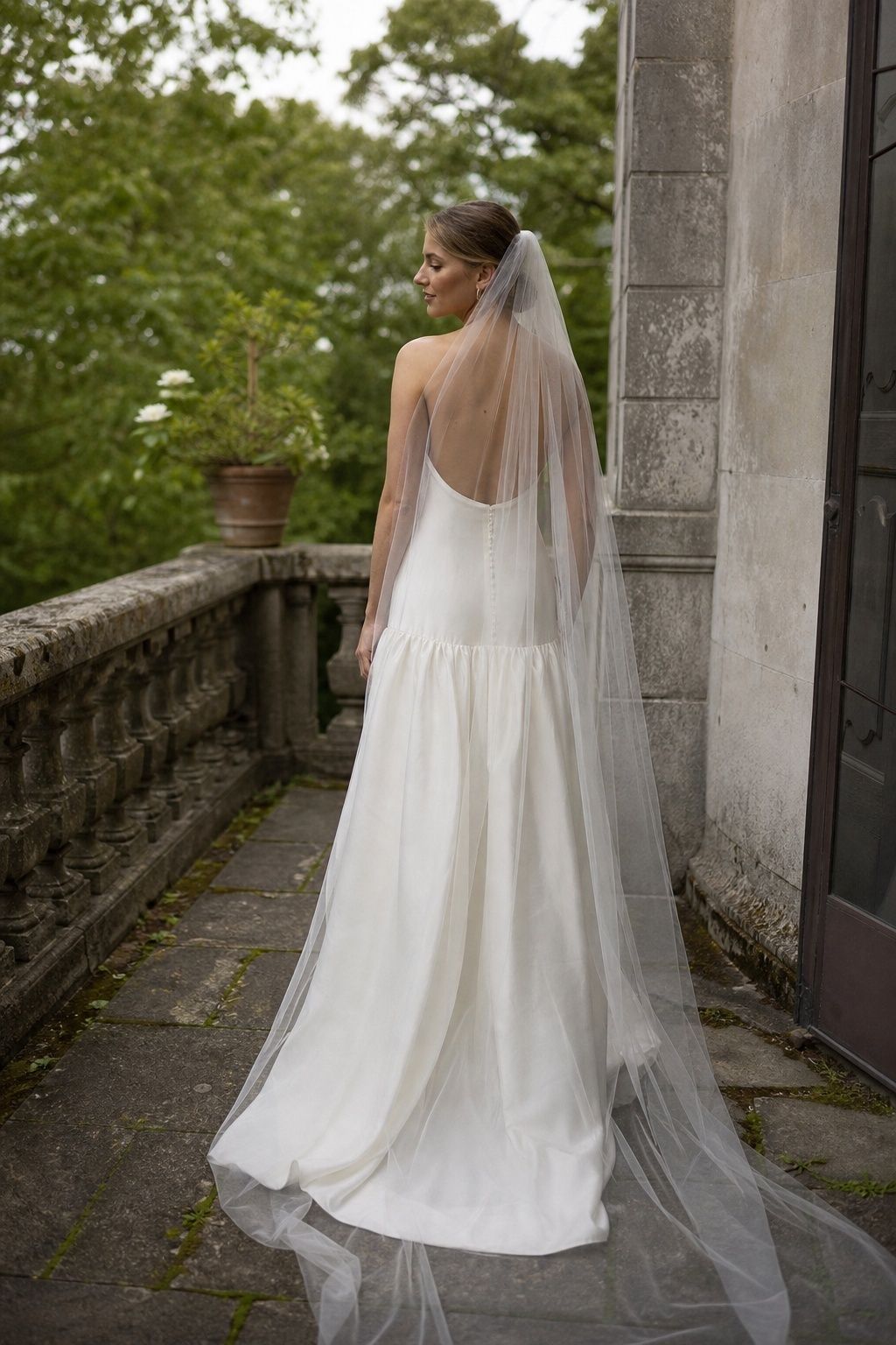 Simple cathedral veil over a gown with a visible dropped waist