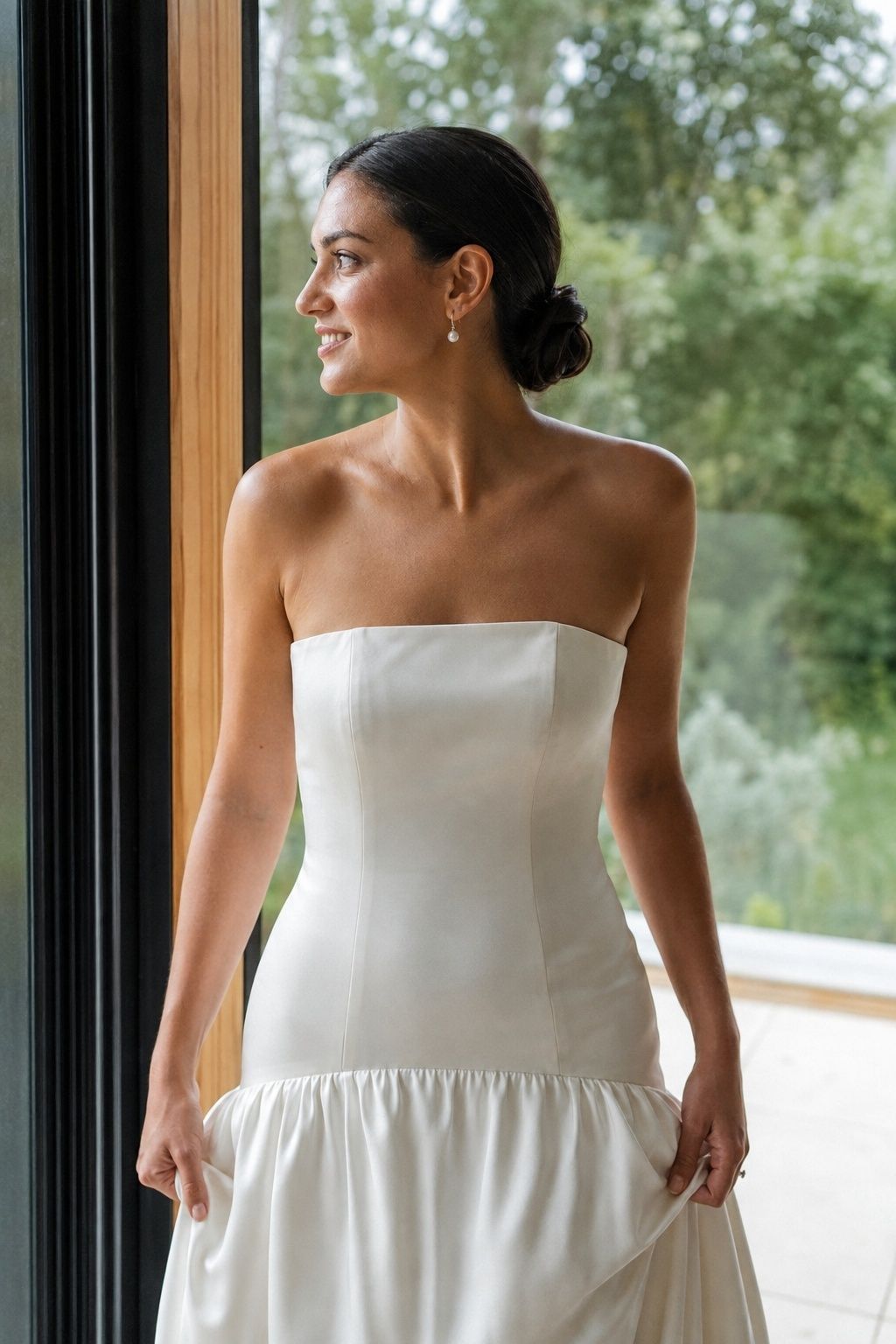 Pearl drop earring and low bun styled with a strapless drop waist gown