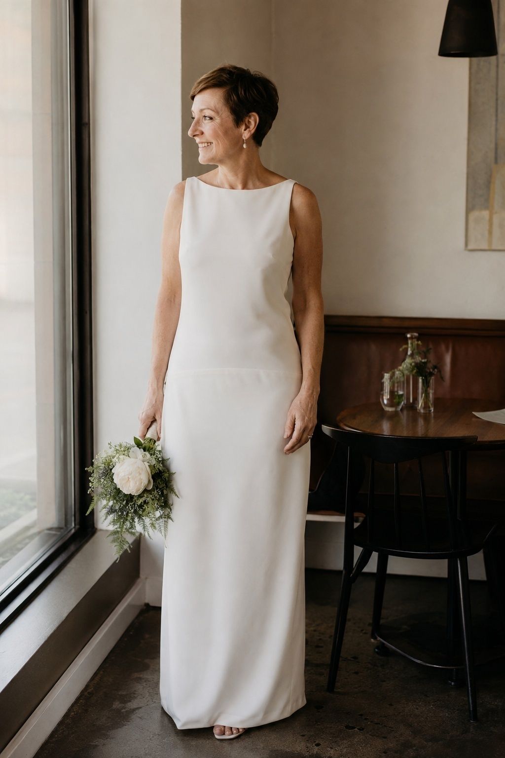 Crepe drop waist sheath with a subtle low seam at a restaurant