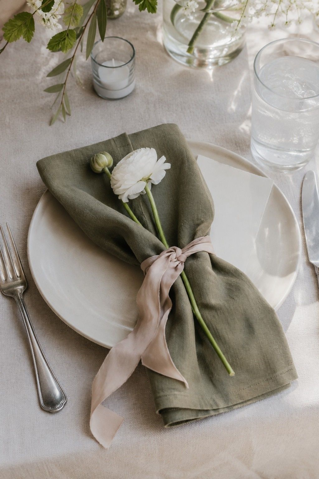 Dusty olive napkins carrying the wedding color