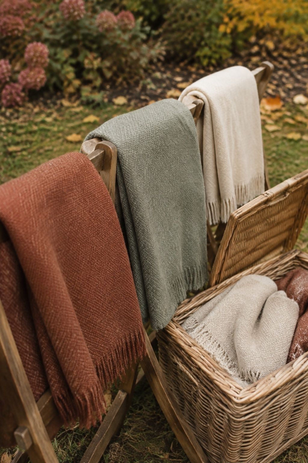 Wool blankets on ceremony chairs with spare wraps in a basket