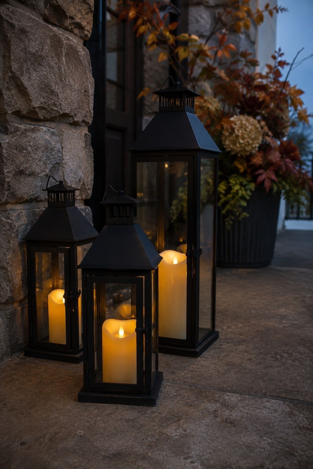 Enclosed lanterns with flameless candles beside a reception entrance