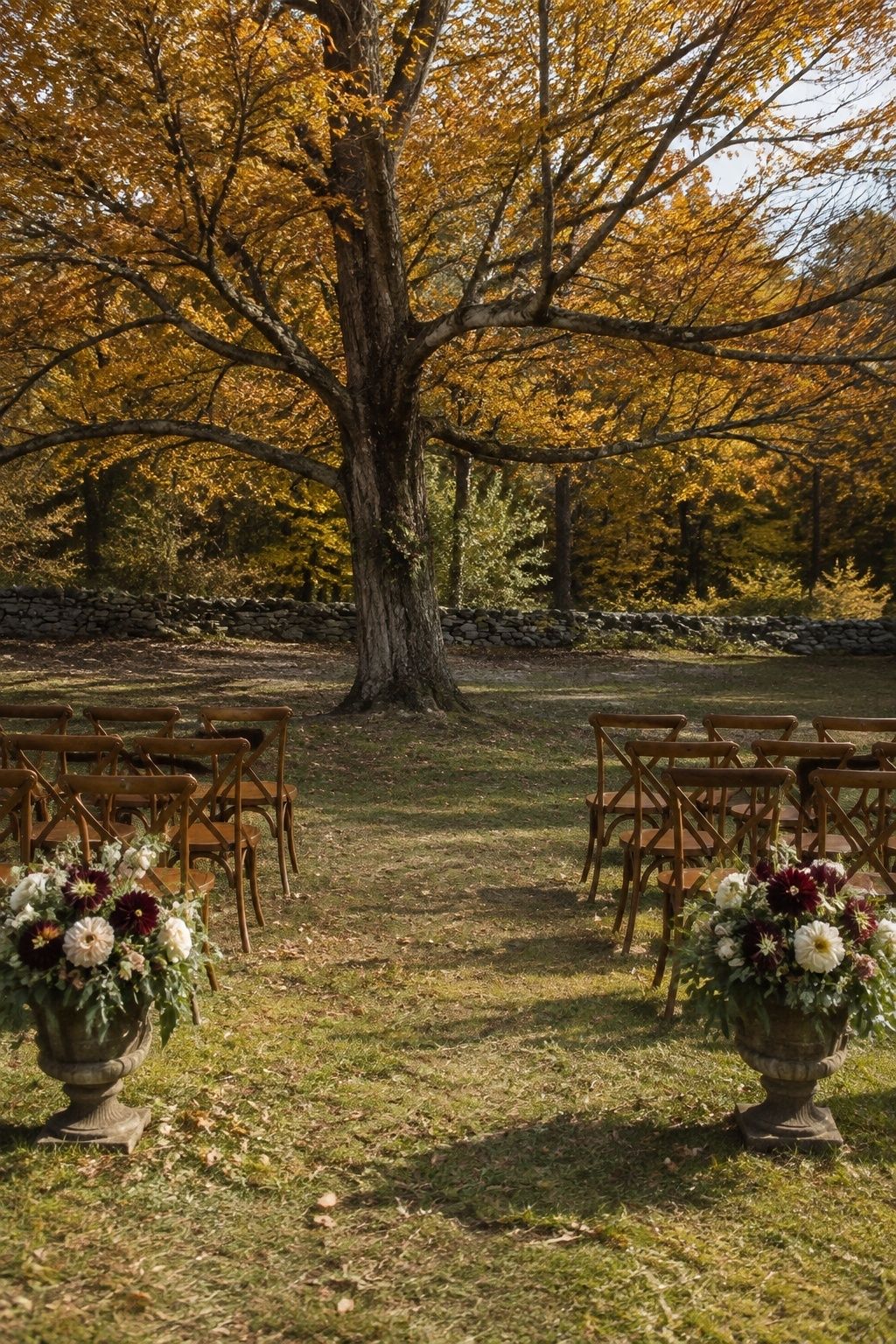 Autumn tree ceremony focal point with grounded floral urns
