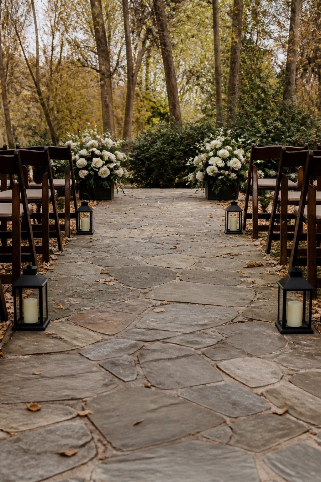Low lanterns lining the edge of a fall wedding aisle