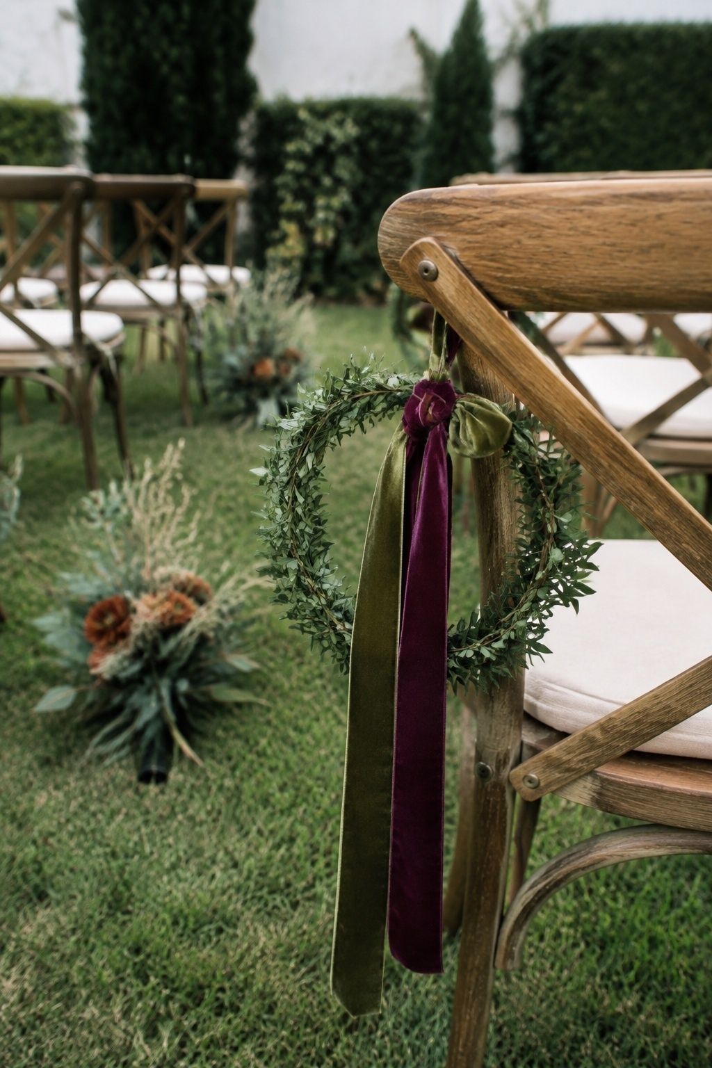 Velvet ribbon streamers on aisle chairs for an autumn touch