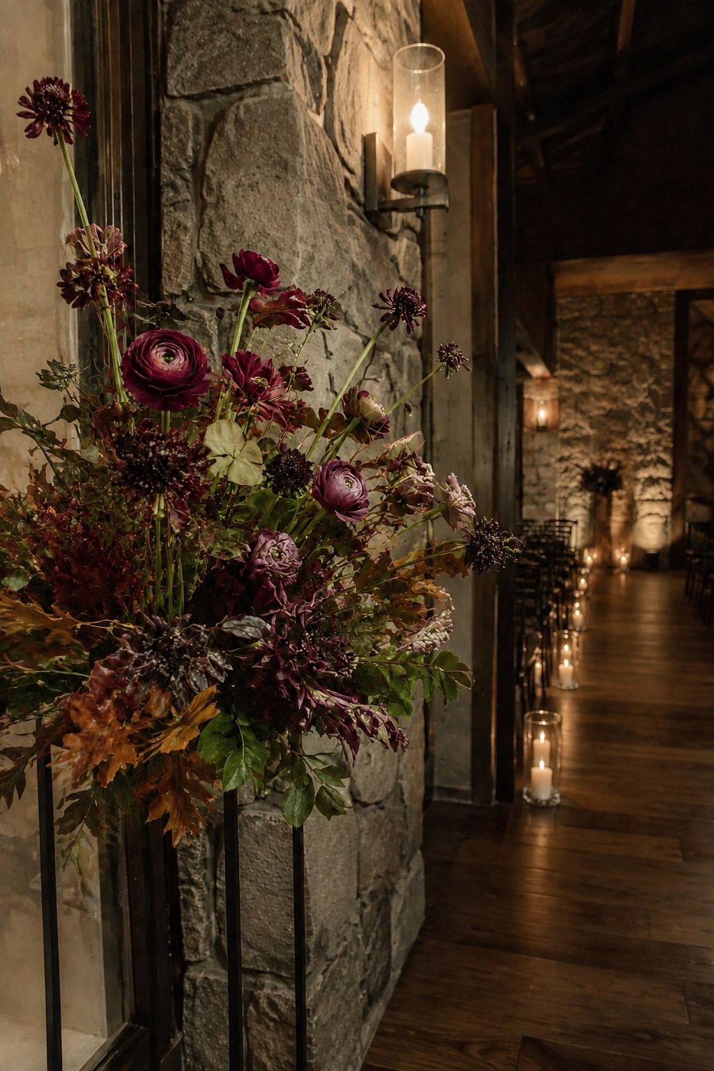 Burgundy floral cluster on an arch for evening vows