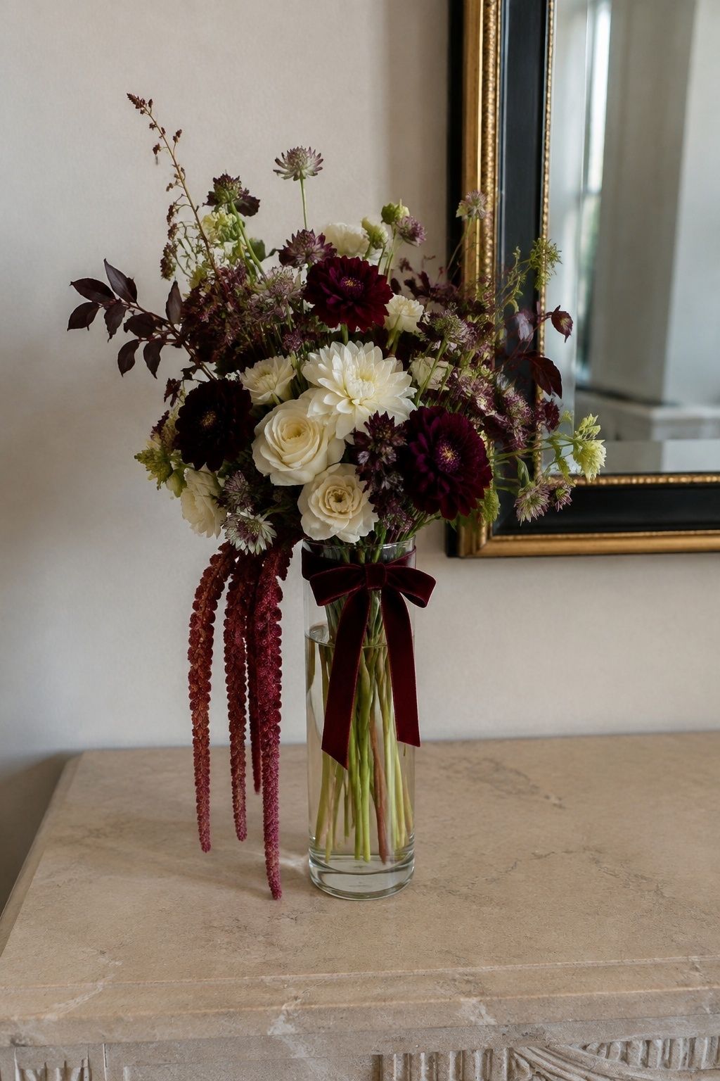 Burgundy amaranthus cascading below a cream and wine bouquet
