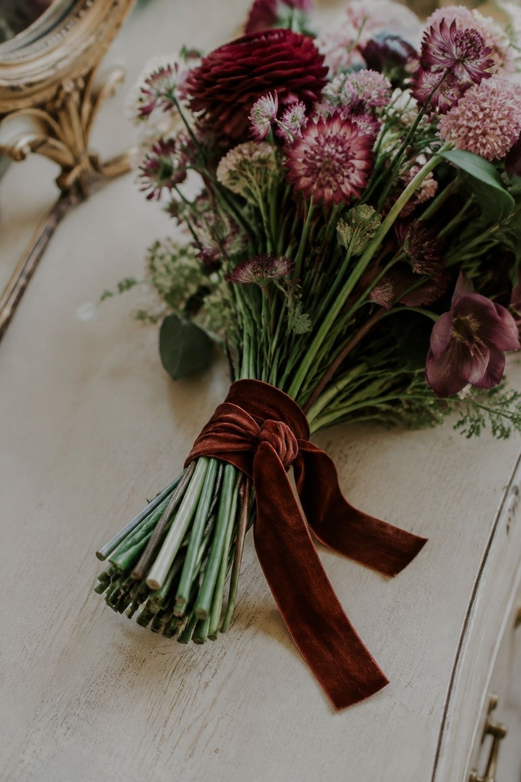 Short cinnamon velvet ribbon around autumn bouquet stems