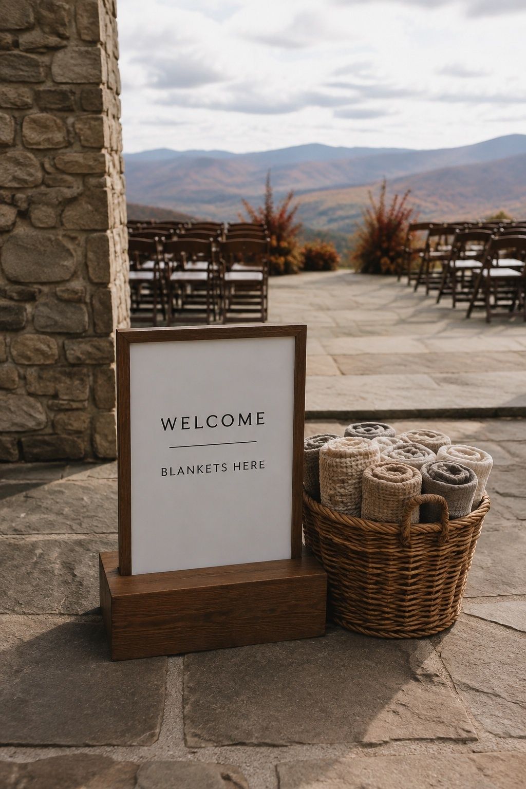 Welcome sign in a heavy wooden stand beside ceremony blankets
