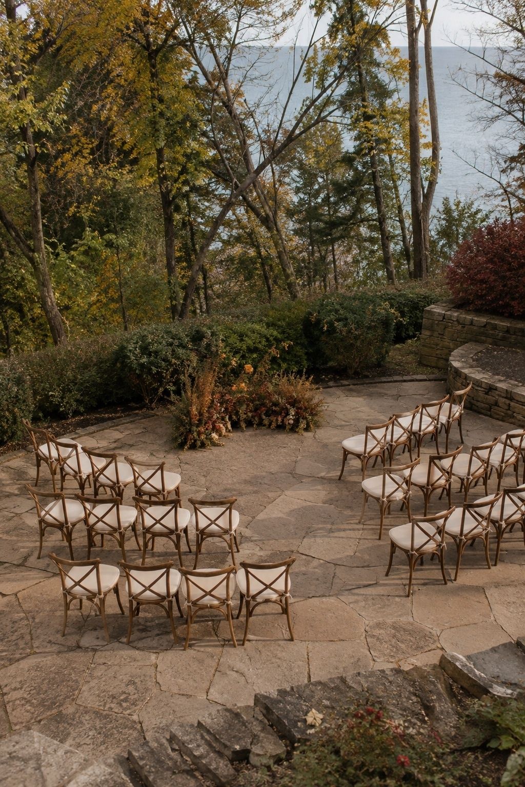 Curved rows of wooden chairs around an intimate autumn vow space