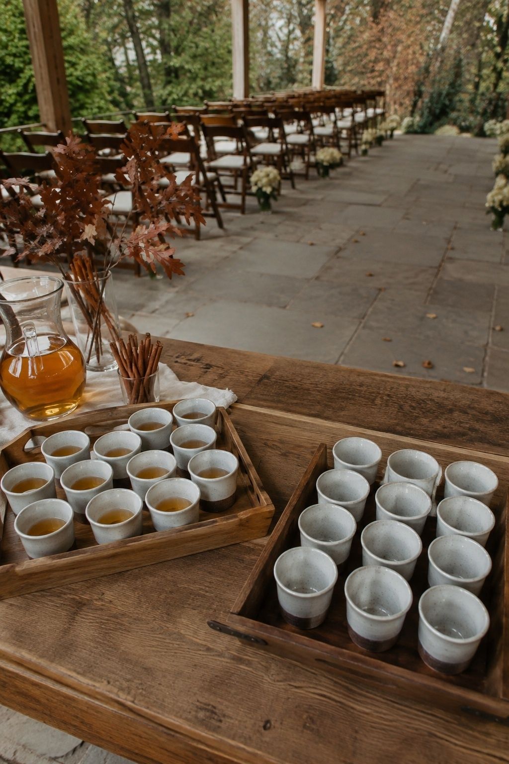Small cider cups and a collection tray at the ceremony entrance