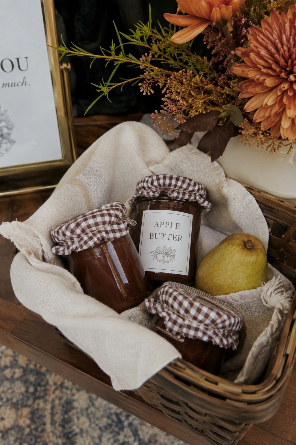 Apple butter jars with gingham lids in a wedding favor basket