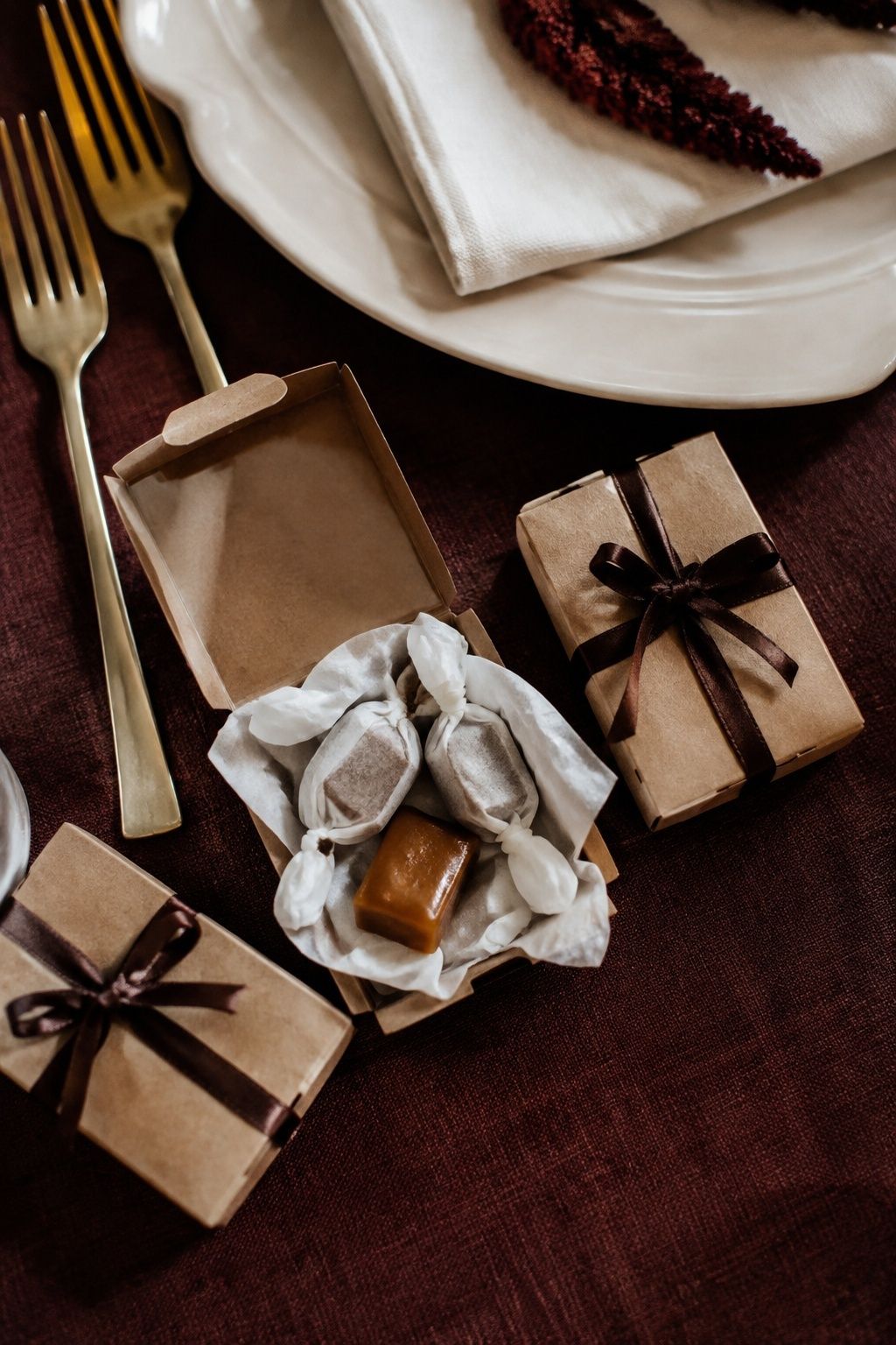 Small caramel favor boxes at an autumn wedding place setting